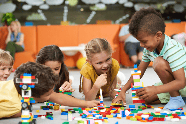 Children paying with Lego
