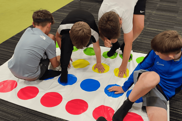 4 boys playing twister